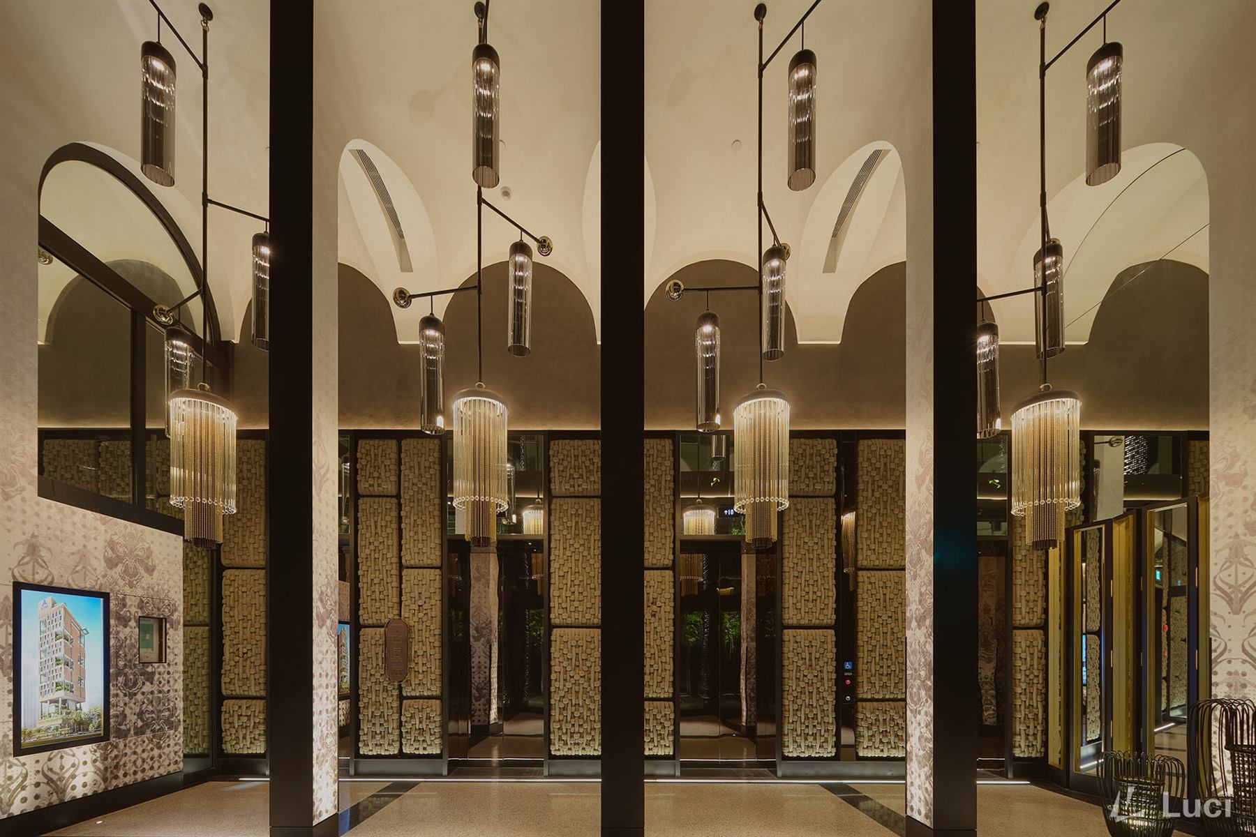 Artyzen Singapore lift lobby with fluted glass and fringed pendant fixtures, vaulted arches and woven wall panels